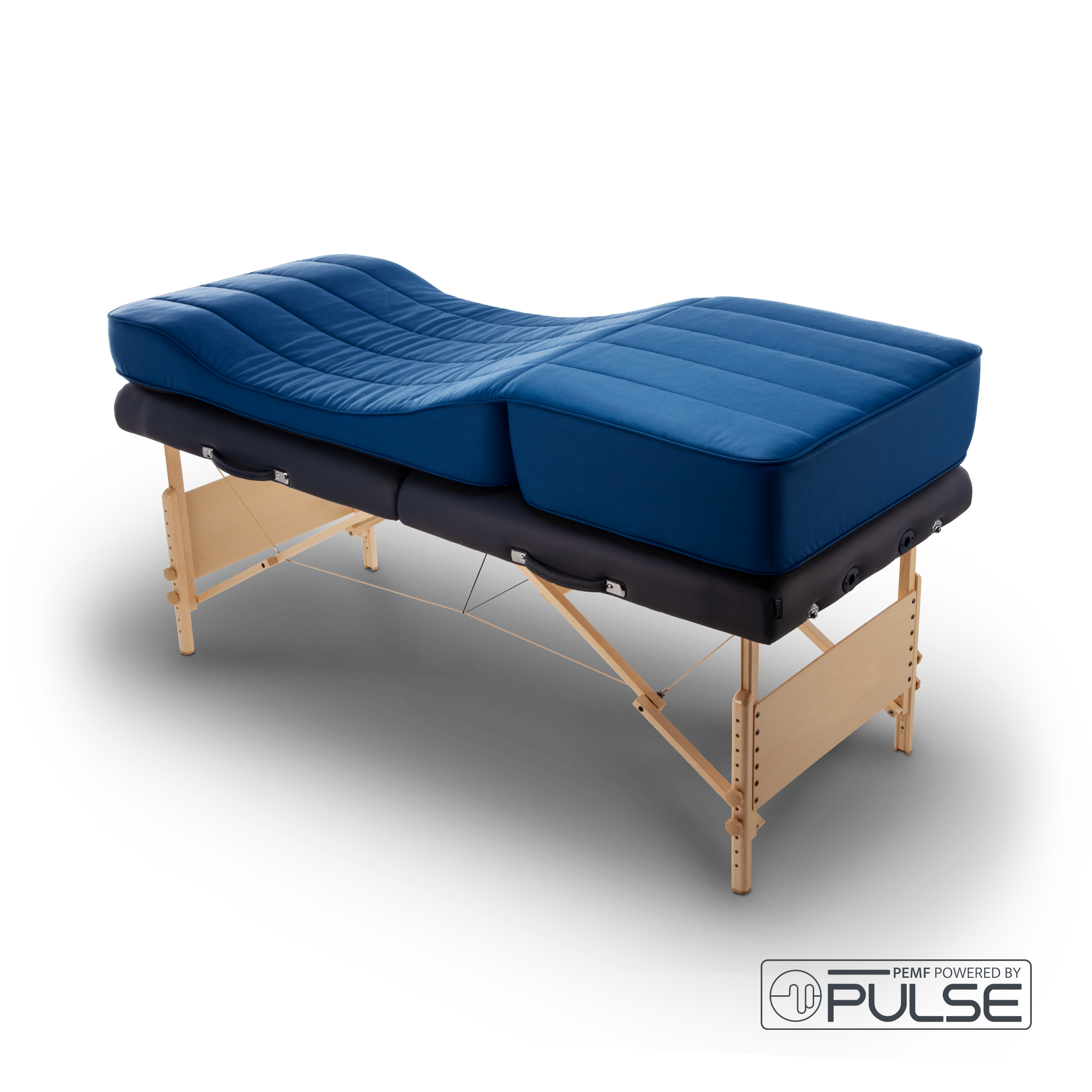 A person lies on a padded table with a gray top, having a beauty or acupuncture treatment. Another person in gloves is delicately performing the treatment, concentrating on the forehead area. The setting is calm, with a textured rug beneath the table and a soft pillow for comfort.